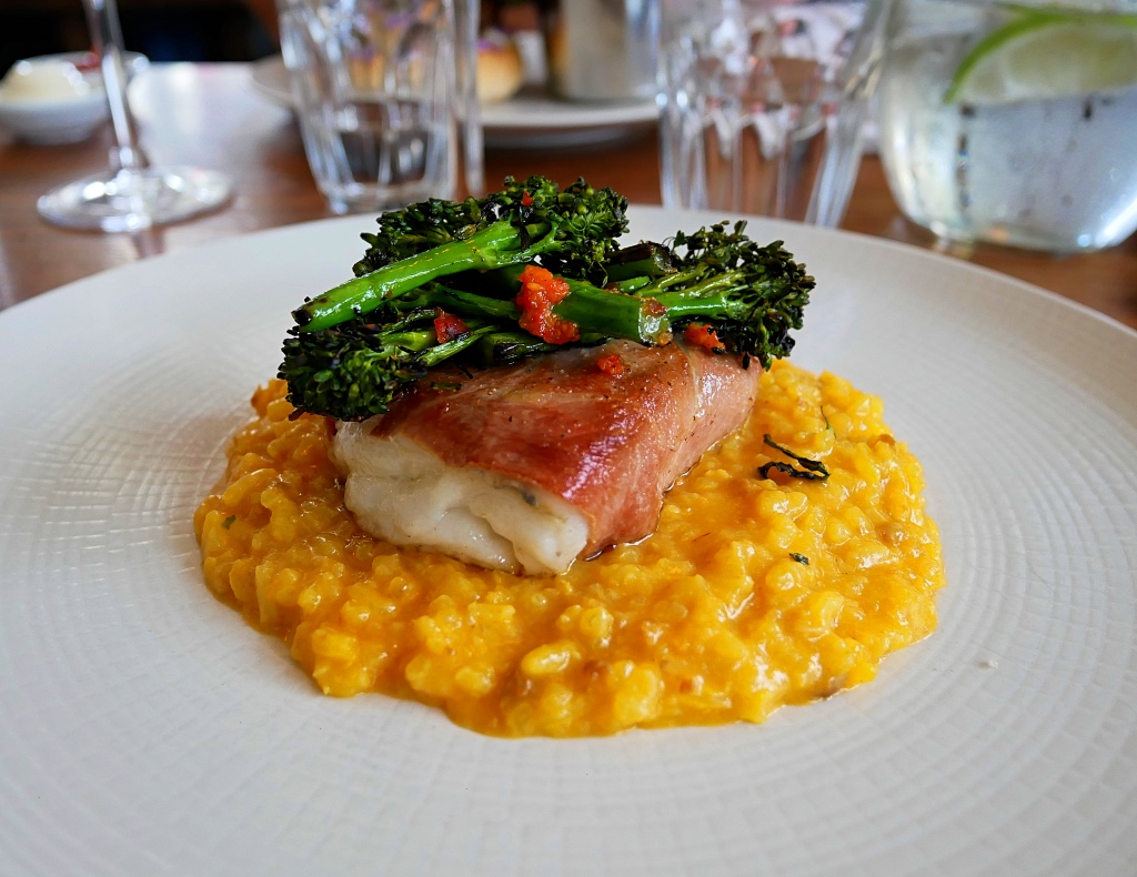 Roasted Hake wrapped in Serrano with a Saffron and Chorizo Risotto